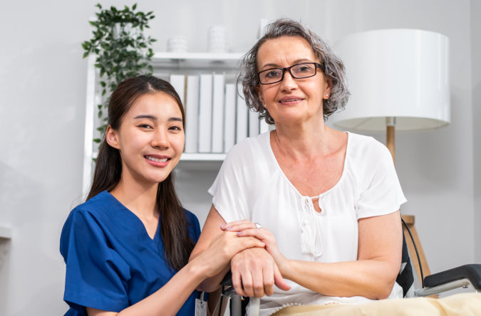 aide taking care of the senior woman