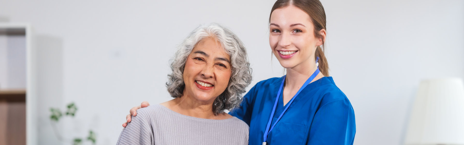 aide and senior woman smiling