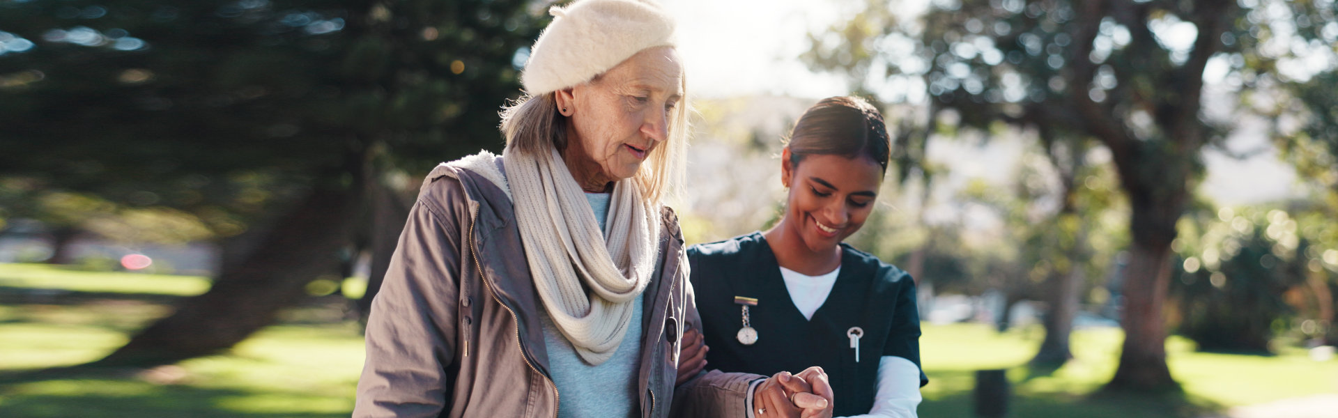 caregiver walking with senior woman